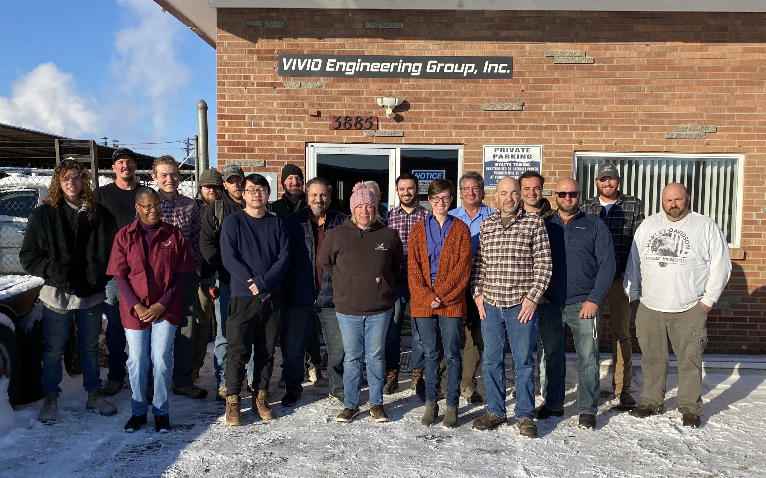The Vivid Engineering Group Denver office staff standing in front of the Denver office posed for a group photo.